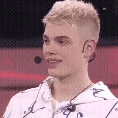Young Man In White Hoodie Smiling With Microphone GIF