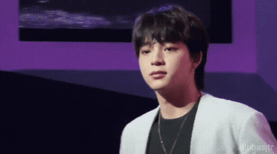 Young Man In White Jacket And Black Shirt GIF