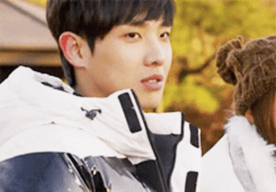 Young Man In White Jacket And Brown Hat Standing Next To Woman GIF