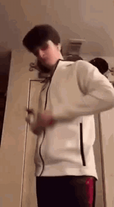 Young Man In White Jacket And Hat At Door GIF