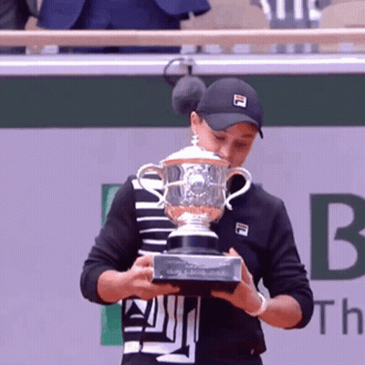 Young Man In White Jacket Holding Road To Kingdom Trophy GIF