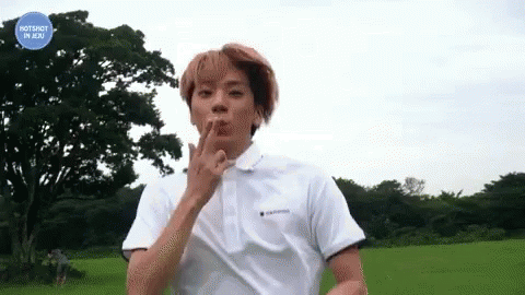 Young Man In White Polo Standing In Field GIF