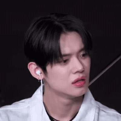 Young Man In White Shirt And Earbuds GIF