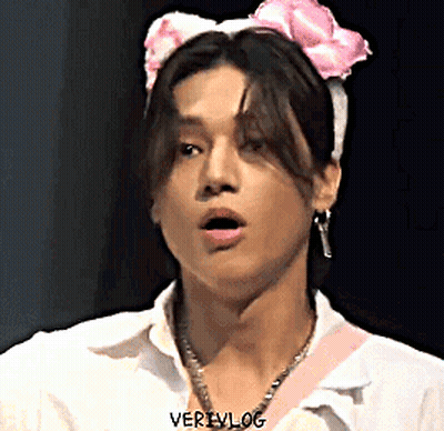 Young Man In White Shirt And Pink Headband With Bow GIF