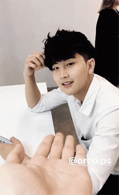 Young Man In White Shirt Hand Reaching Out GIF