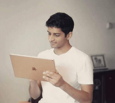 Young Man In White Shirt Holding Apple IPad GIF