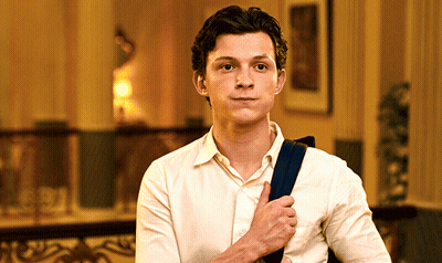 Young Man In White Shirt Holding Blue Bag GIF