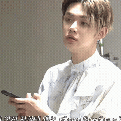 Young Man In White Shirt Holding Cell Phone GIF