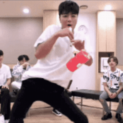 Young Man In White Shirt Holding Red Cup GIF