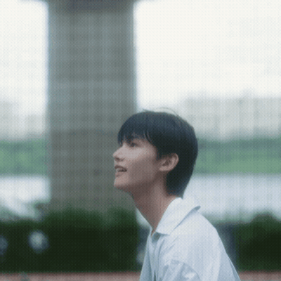 Young Man in White Shirt Looking Up