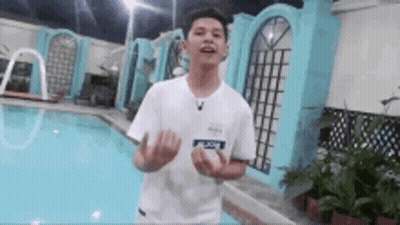 Young Man In White Shirt Next To Pool GIF