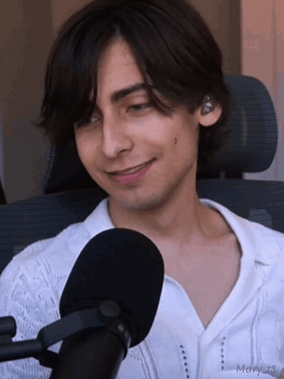 Young Man In White Shirt Smiling At Microphone GIF