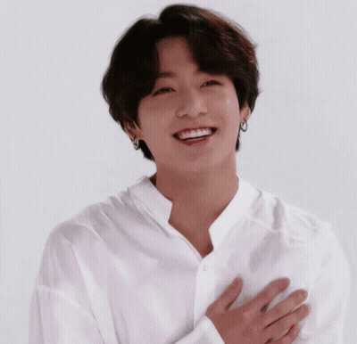 Young Man In White Shirt Smiling Hands To Chest GIF