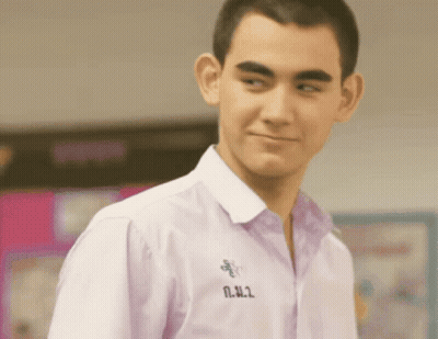 Young Man In White Shirt With N.N.2 On Collar GIF
