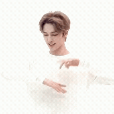 Young Man In White Sweater Dancing With Hands Outstretched GIF