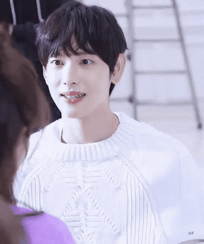 Young Man In White Sweater Smiling At Woman GIF