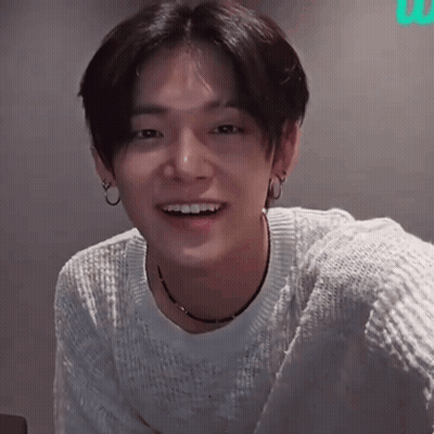 Young Man In White Sweater Smiling With Hoop Earrings GIF
