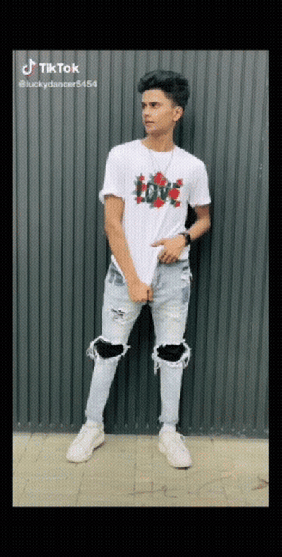 Young Man in White T-Shirt and Ripped Jeans