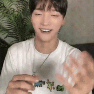 Young Man In White T-Shirt With Ocean Smiling GIF