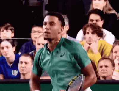 Young Man In White Tank Top Looking Down In Store GIF