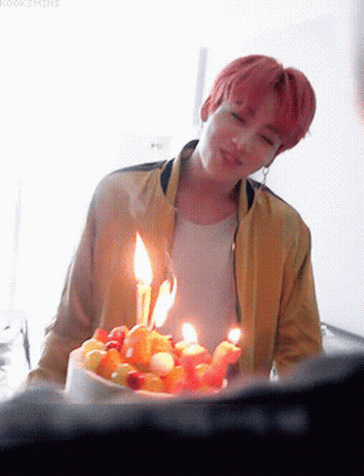 Young Man In Yellow Jacket With Birthday Cake GIF