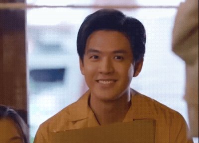 Young Man In Yellow Shirt Holding Clipboard GIF