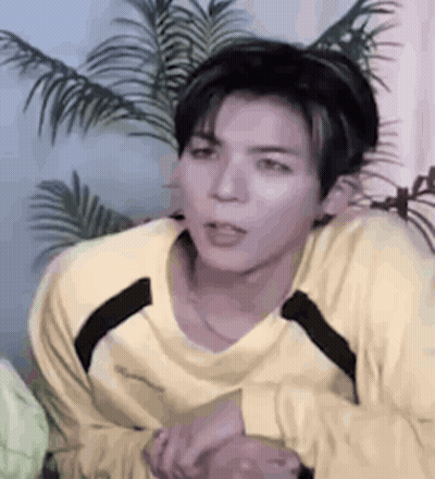 Young Man In Yellow Shirt Sitting GIF