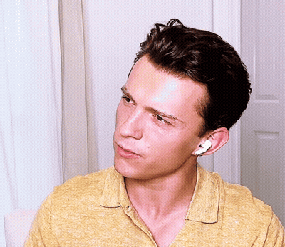 Young Man In Yellow Shirt With Earbuds GIF