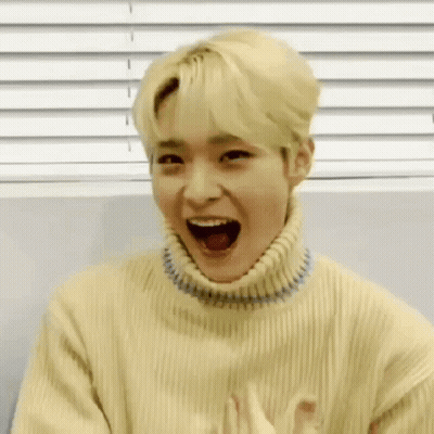 Young Man In Yellow Sweater Making Funny Face GIF