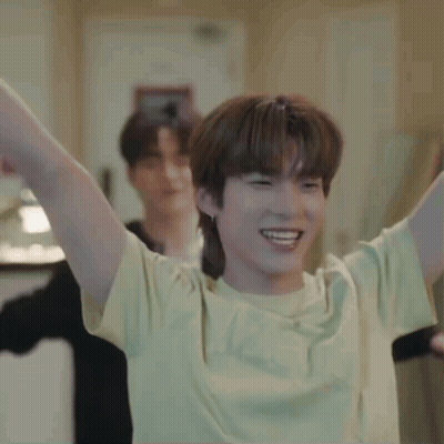 Young Man In Yellow T-Shirt Raising Arms GIF