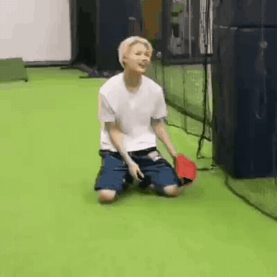 Young Man Kneeling With Baseball Bat GIF