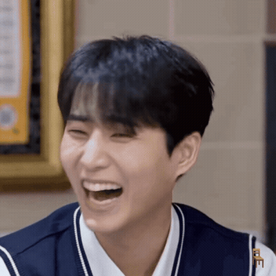 Young Man Laughing With Letter E On Chest GIF