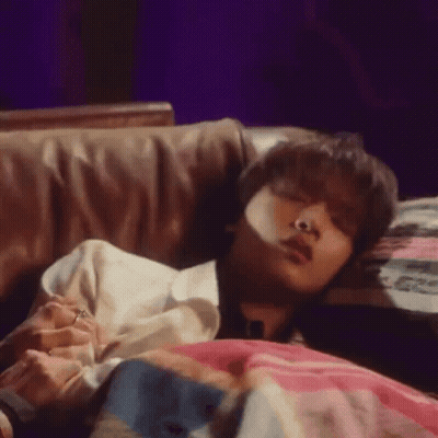 Young Man Laying On Bed With Blanket And Pillow GIF