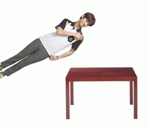 Young Man Leaning On Wooden Table GIF