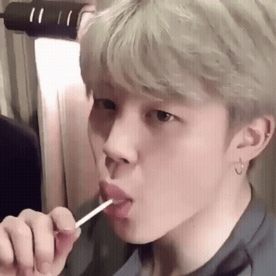 Young Man Licking Lollipop GIF