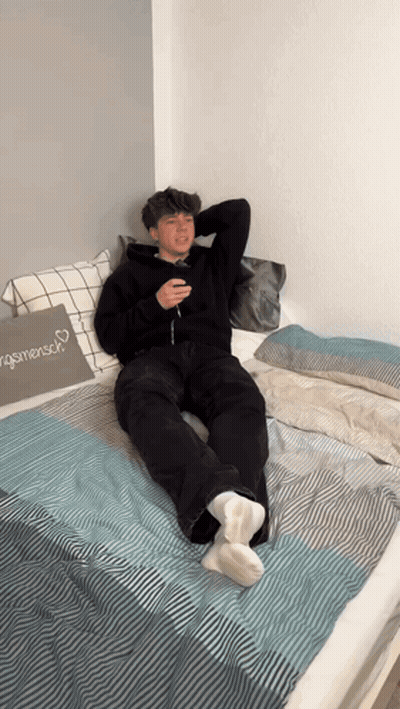 Young Man Lying On Bed With Menschen Pillow GIF