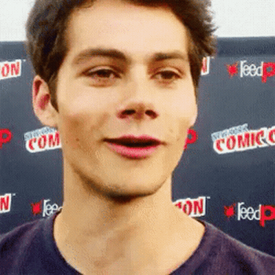 Young Man Making Funny Face at Comic Con Wall