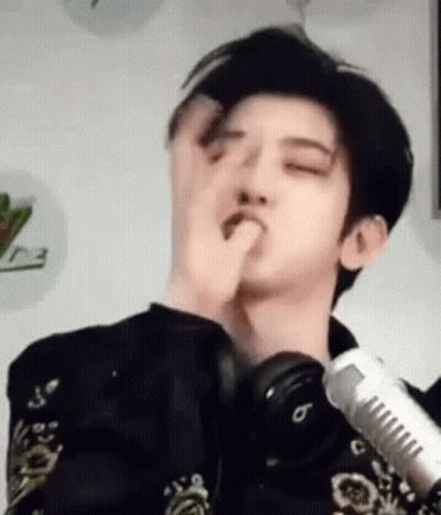 Young Man Making Funny Face At Microphone With Headphones GIF