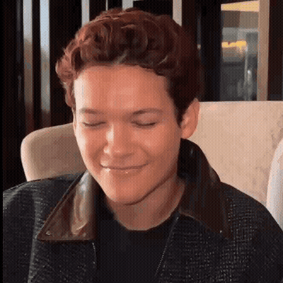 Young Man Making Funny Face In Chair GIF