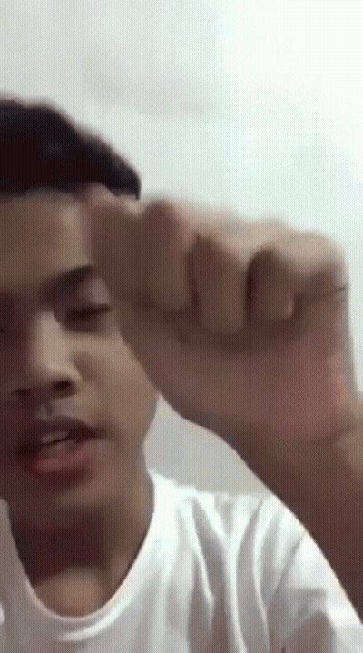 Young Man Making Funny Face With Fist Up GIF