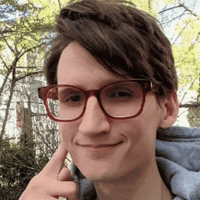 Young Man Making Funny Face With Glasses And Blue Hoodie GIF