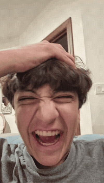 Young Man Making Funny Face With Hand On Head GIF