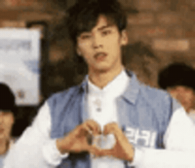 Young Man Making Heart Shape With Hands GIF