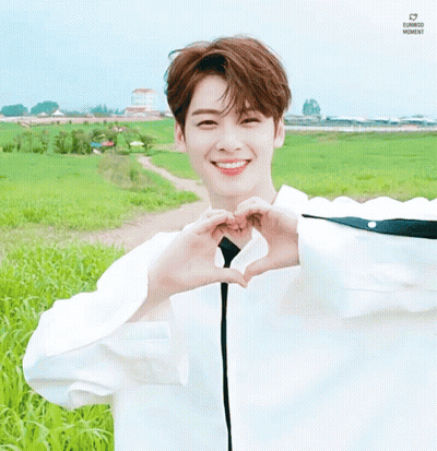Young Man Making Heart With Hands In Field GIF