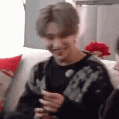 Young Man On Couch Holding Phone Making Funny Face GIF