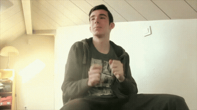 Young Man On Couch In Black Shirt With Drawing GIF