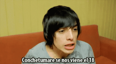Young Man On Red Couch Saying Conchetumare Se Nos Viene El 18 GIF