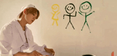 Young Man Painting Stick Figures On Wall GIF