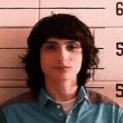 Young Man Posing In Front Of Police Line GIF