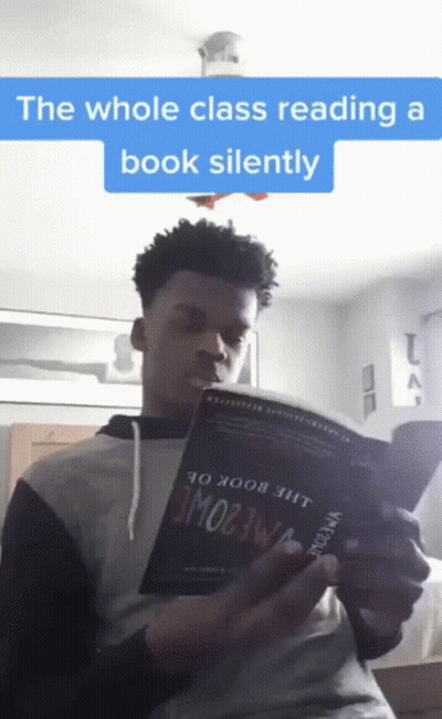 Young Man Reading Whole Class Book Silently GIF